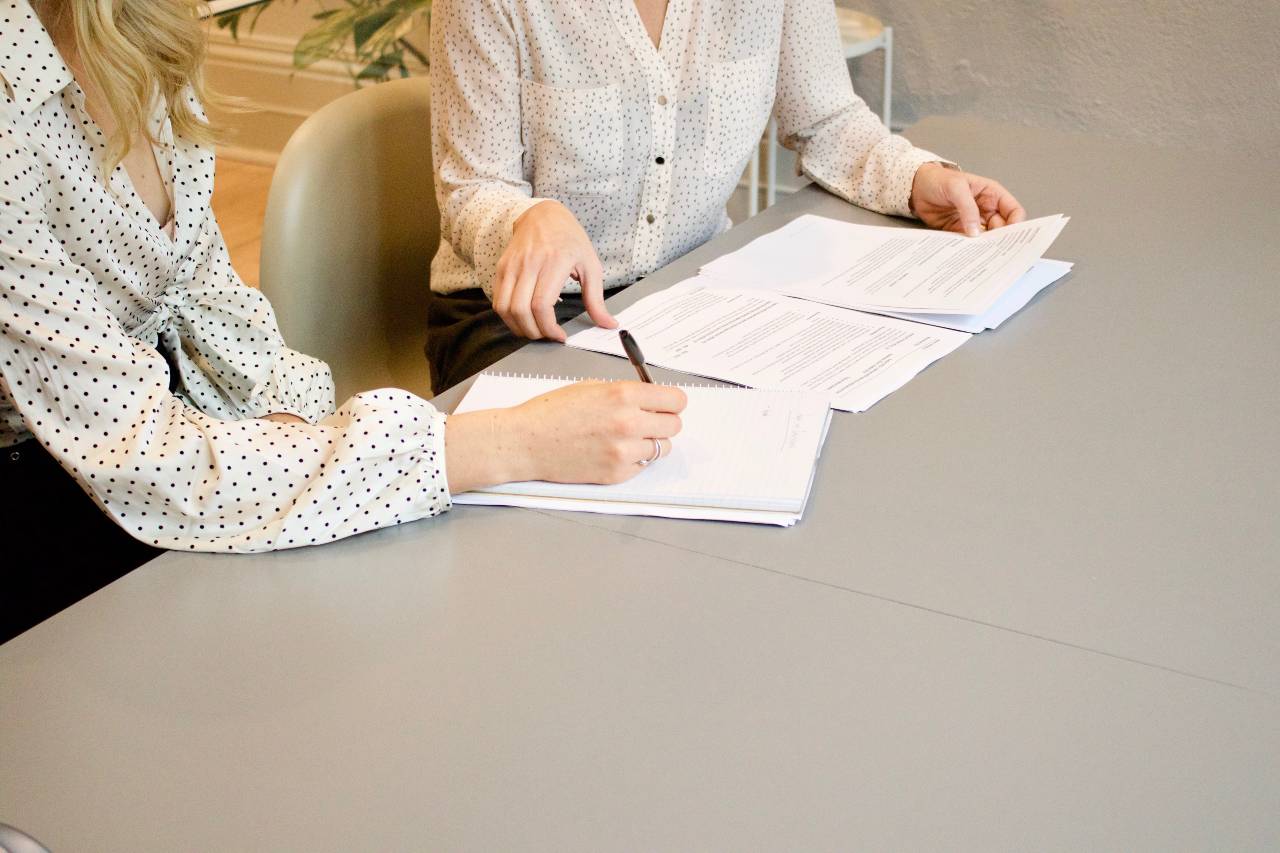 two business women reviewing a contract